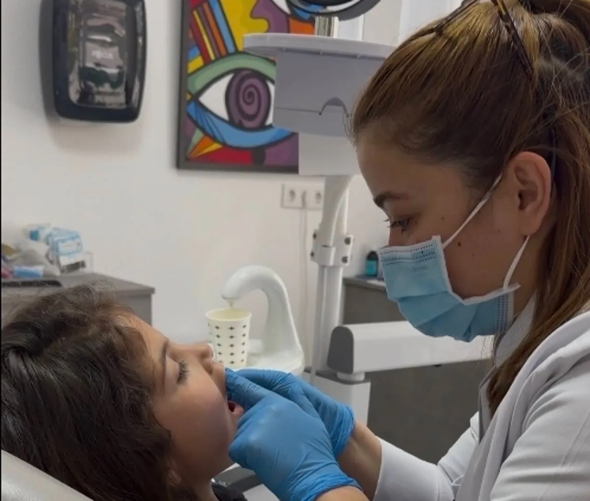 Dt. Damla Taşcıoğlu examining a young patient